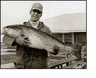 Man Holding Large Red Drum