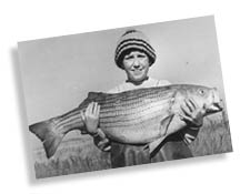 Kid with large striped bass